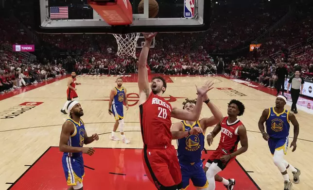 Houston Rockets center Alperen Sengun (28) shoots agasint Golden State Warriors guard Brandin Podziemski (2) during the first half of Game 1 of an NBA basketball first-round playoff series in Houston, Sunday, April 20, 2025. (AP Photo/Ashley Landis)