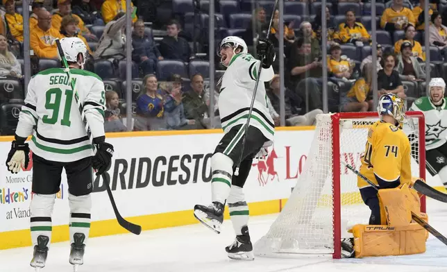 Dallas Stars left wing Mason Marchment, center, celebrates his goal with center Tyler Seguin (91) during the first period of an NHL hockey game against the Nashville Predators, Wednesday, April 16, 2025, in Nashville, Tenn. (AP Photo/George Walker IV)