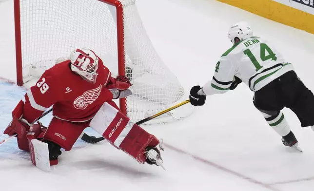 Dallas Stars left wing Jamie Benn (14) scores on Detroit Red Wings goaltender Cam Talbot (39) in the first period of an NHL hockey game Monday, April 14, 2025, in Detroit. (AP Photo/Paul Sancya)
