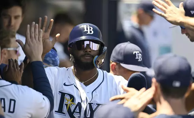 Tampa Bay Rays' Junior Caminero celebrates scoring on a single by José Caballero (not pictured) during the first inning of a baseball game against the Atlanta Braves, Sunday, April 13, 2025, in Tampa, Fla. (AP Photo/Jason Behnken)