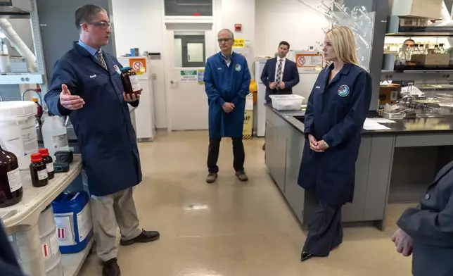 Attorney General Pam Bondi, right, listens as David Guthrie, a senior research chemist with the Drug Enforcement Administration speaks during a tour of a DEA research laboratory on Tuesday, April 29, 2025, in Northern Virginia. (AP Photo/Mark Schiefelbein)