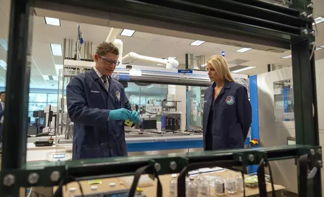 Attorney General Pam Bondi, right, watches as Jonathan Dumke, left, a senior forensic chemist with the Drug Enforcement Administration, demonstrates the use of a test strip used to detect the presence of fentanyl at a DEA research laboratory on Tuesday, April 29, 2025, in Northern Virginia. (AP Photo/Mark Schiefelbein)