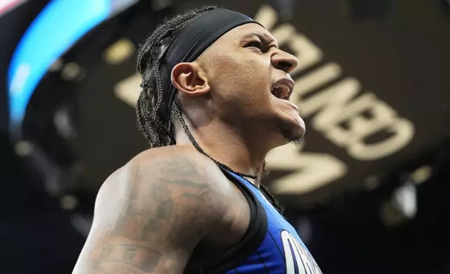 Orlando Magic forward Paolo Banchero celebrates after making a shot and drawing a foul during the second half of an NBA play-in tournament basketball game against the Atlanta Hawks, Tuesday, April 15, 2025, in Orlando, Fla. (AP Photo/John Raoux)