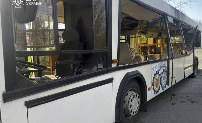 In this photo provided by the Ukrainian Emergency Service, a damaged bus that was hit by the Russian drone in Marhanets, Dnipropetrovsk region, Wednesday, April 23, 2025. (Ukrainian Emergency Service via AP)
