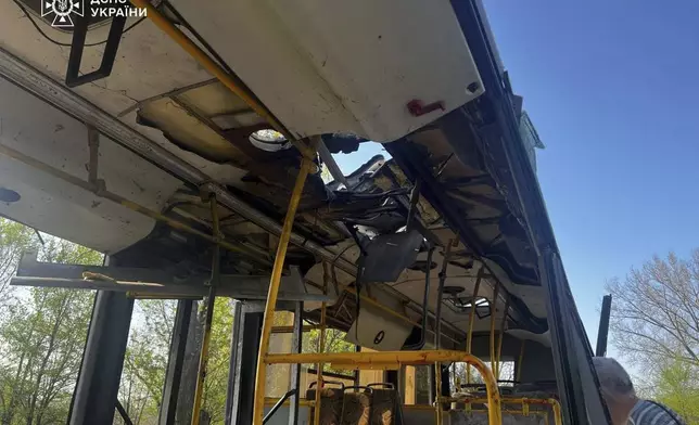 In this photo provided by the Ukrainian Emergency Service, a damaged bus that was hit by the Russian drone in Marhanets, Dnipropetrovsk region, Wednesday, April 23, 2025. (Ukrainian Emergency Service via AP)