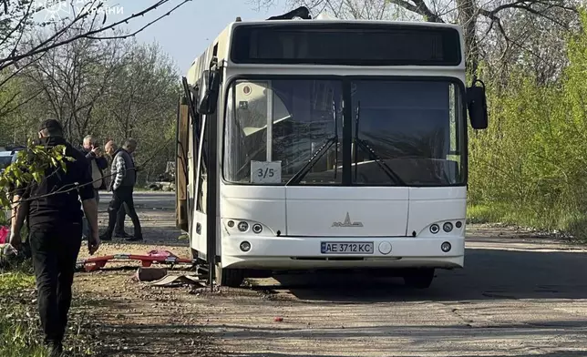 In this photo provided by the Ukrainian Emergency Service, a damaged bus that was hit by the Russian drone in Marhanets, Dnipropetrovsk region, Wednesday, April 23, 2025. (Ukrainian Emergency Service via AP)