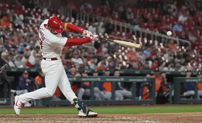 St. Louis Cardinals' Nolan Arenado hits an RBI double during the fifth inning of a baseball game against the Houston Astros Monday, April 14, 2025, in St. Louis. (AP Photo/Jeff Roberson)