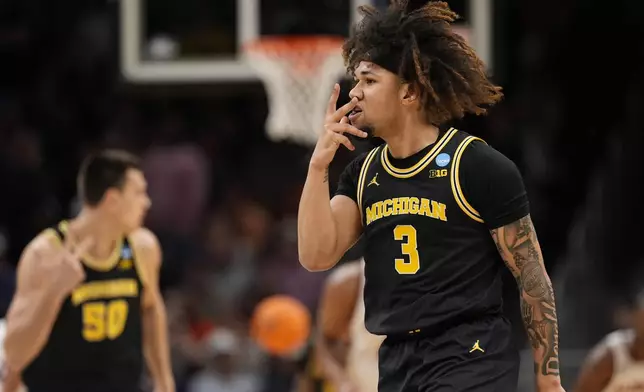 Michigan guard Tre Donaldson (3) reacts to a three-point shot against Auburn during the first half in the Sweet 16 of the NCAA college basketball tournament, Friday, March 28, 2025, in Atlanta. (AP Photo/George Walker IV)