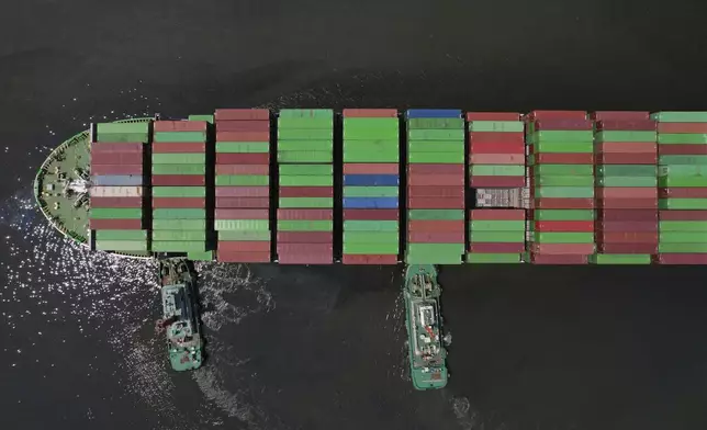 Tugboats assist a container ship as it prepares to dock at the Manila International Container Terminal at the Philippine capital on Tuesday, April 8, 2025. (AP Photo/Aaron Favila)
