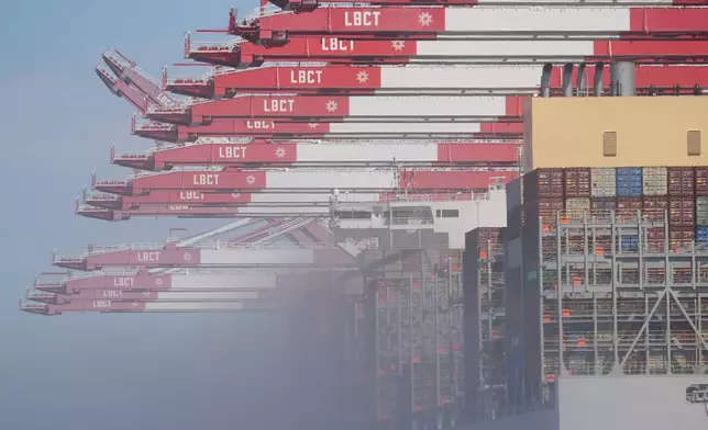 The "OOCL Bauhinia" container ship is covered by fog as it moors at the Long Beach Container Terminal at Middle Harbor in the Port of Long Beach, Calif., Tuesday, April 8, 2025. (AP Photo/Damian Dovarganes)