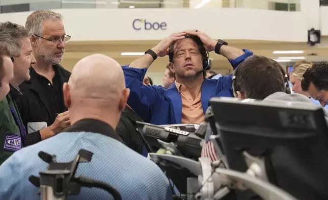 A trader reacts as other traders work on the options trading floor at the Cboe Global Markets in Chicago, Tuesday, April 8, 2025. (AP Photo/Nam Y. Huh)