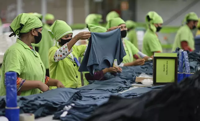Factory workers check the garments before dispatching to their clients at UHM Ltd. in Narayaganj, Bangladesh, Tuesday, April 8, 2025. (AP Photo/Mahmud Hossain Opu)