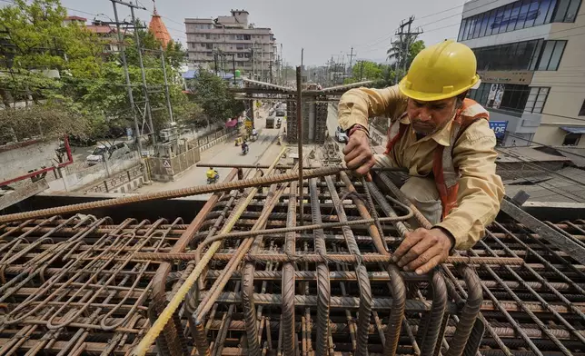 A labourer works on the construction of a bridge in Guwahati, India, Tuesday, April 8, 2025. (AP Photo/Anupam Nath)