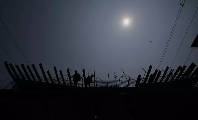 Labourers work on the construction of a bridge in Guwahati, India, Tuesday, April 8, 2025. (AP Photo/Anupam Nath)