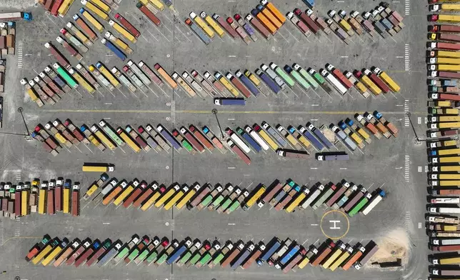 In this aerial view, trucks and containers are parked at Iraq's main port of Umm Qasr, near the city of Basra, 340 miles (550 kilometers) southeast of Baghdad, Iraq, Wednesday, April 9, 2025. (AP Photo/Nabil al-Jourani)