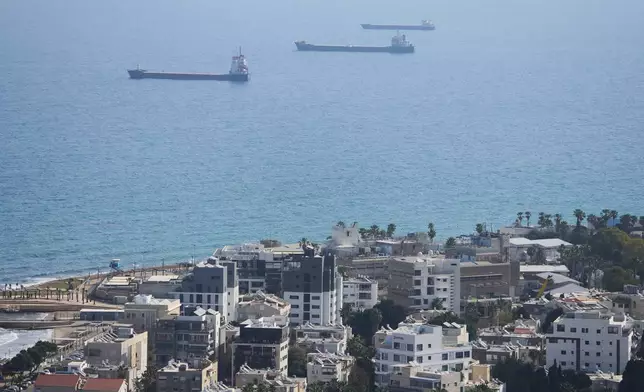 Merchant ships wait outside Haifa's port, Israel, Wednesday, April 9, 2025. (AP Photo/Ariel Schalit)