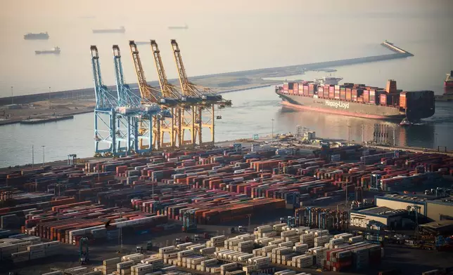 A cargo ship full of containers leaves the cargo terminal at the port of Barcelona, Spain, Tuesday, April 8, 2025. (AP Photo/Emilio Morenatti)