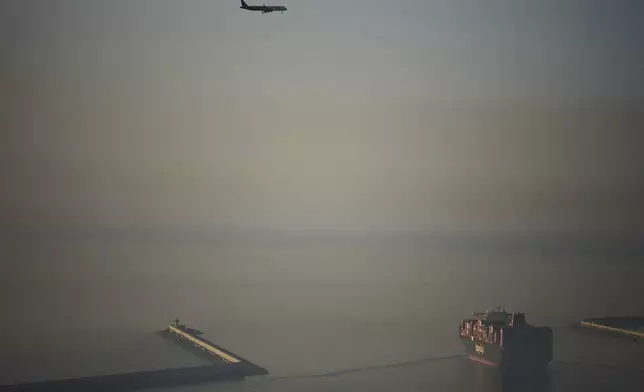 A cargo ship laden with containers leaves the cargo terminal at the port of Barcelona, Spain, Tuesday, April 8, 2025. (AP Photo/Emilio Morenatti)