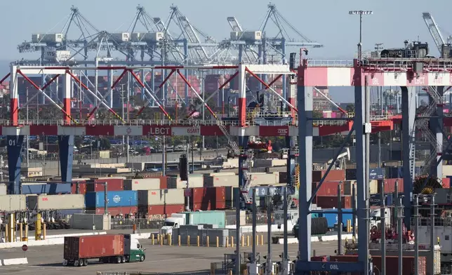 Containers are transported by trains and trucks out of the Long Beach Container Terminal in the Port of Long Beach, Calif., Tuesday, April 8, 2025. (AP Photo/Damian Dovarganes)