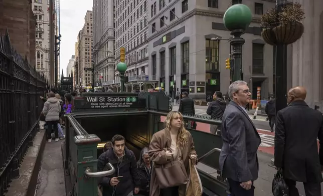 Commuters arrive at Wall Street station, Tuesday, April 8, 2025, in New York. (AP Photo/Yuki Iwamura)