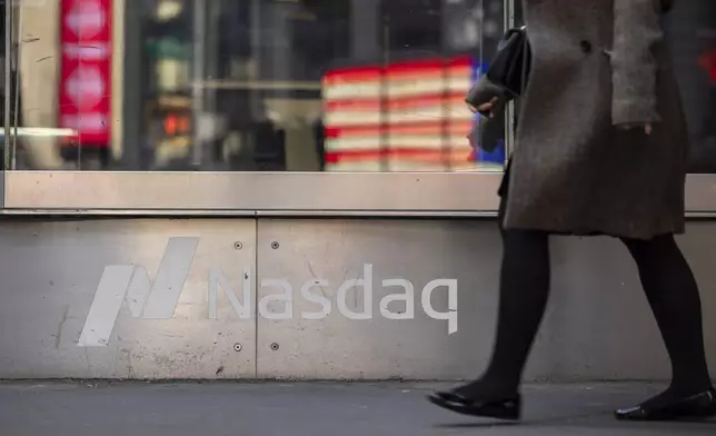 A person walks past the Nasdaq MarketSite, Thursday, April 10, 2025, in New York. (AP Photo/Yuki Iwamura)