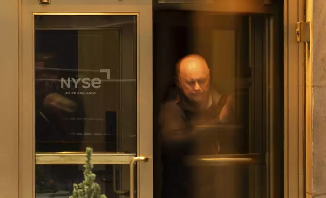 A person walks out of the New York Stock Exchange, Thursday, April 10, 2025, in New York. (AP Photo/Yuki Iwamura)