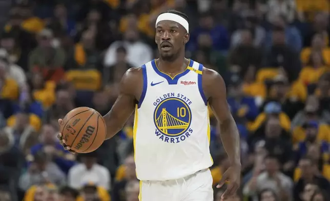 Golden State Warriors forward Jimmy Butler III brings the ball up the court against the Memphis Grizzlies during the first half of an NBA play-in tournament basketball game in San Francisco, Tuesday, April 15, 2025. (AP Photo/Jeff Chiu)