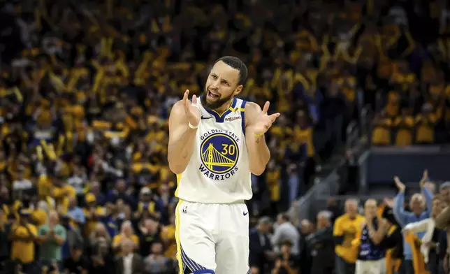 Golden State Warriors' Stephen Curry (30) claps and urges on the crowd in the second half of an NBA play-in tournament basketball game against the Memphis Grizzlies in San Francisco, on Tuesday, April 15, 2025. (Carlos Avila Gonzalez/San Francisco Chronicle via AP)