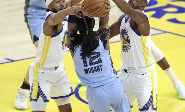 State Warriors' Moses Moody, left, and Jimmy Butler III (10) defend against Memphis Grizzlies' Ja Morant (12) during the first half of during an NBA play-in tournament basketball game in San Francisco, Tuesday, April 15, 2025. (Scott Strazzante/San Francisco Chronicle via AP)