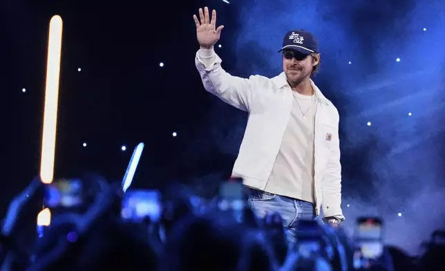 Actor Ryan Gosling waves at audience members during a fan convention called the Star Wars Celebration in Chiba, near Tokyo, Friday, April 18, 2025. (AP Photo/Hiro Komae)
