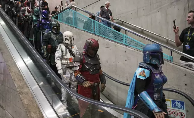 Star Wars fans in different creations of the Boba Fett uniforms attend a fan convention, the Star Wars Celebration in Chiba, near Tokyo, Friday, April 18, 2025. (AP Photo/Hiro Komae)