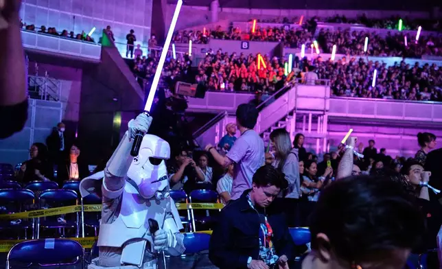 Fans react to the opening act during the Star Wars Celebration in Chiba, near Tokyo, Friday, April 18, 2025. (AP Photo/Hiro Komae)