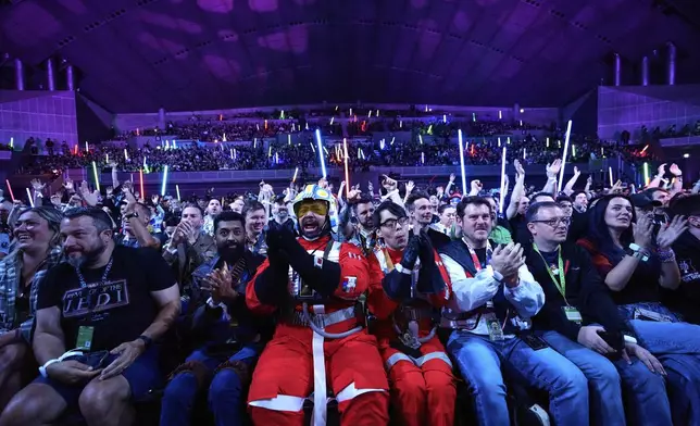 Fans react to the opening act during the Star Wars Celebration at the Makuhari Messe convention center in Chiba, near Tokyo, Friday, April 18, 2025. (AP Photo/Hiro Komae)