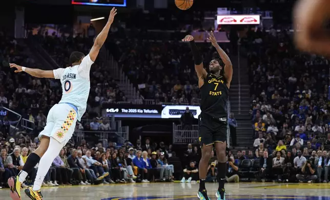 Golden State Warriors guard Buddy Hield (7) shoots a 3-point basket next to San Antonio Spurs forward Keldon Johnson (0) during the first half of an NBA basketball game Wednesday, April 9, 2025, in San Francisco. (AP Photo/Godofredo A. Vásquez)