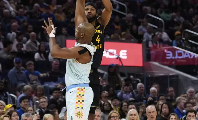 Golden State Warriors guard Moses Moody (4) shoots a 3-point basket over San Antonio Spurs guard Chris Paul (3) during the first half of an NBA basketball game Wednesday, April 9, 2025, in San Francisco. (AP Photo/Godofredo A. Vásquez)