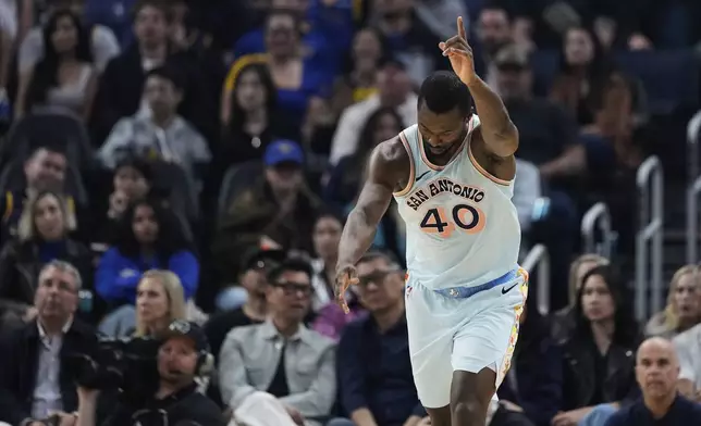 San Antonio Spurs forward Harrison Barnes reacts after making a 3-point basket during the first half of an NBA basketball game against the Golden State Warriors, Wednesday, April 9, 2025, in San Francisco. (AP Photo/Godofredo A. Vásquez)