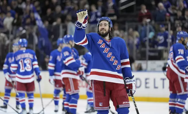 New York Rangers' Mika Zibanejad waves at someone in the crowd after an NHL hockey game against the Tampa Bay Lightning in New York, Thursday, April 17, 2025. (AP Photo/Seth Wenig)