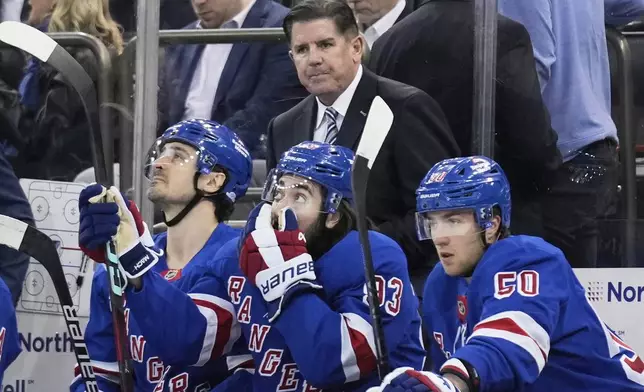 New York Rangers coach Peter Laviolette, top, watches during the first period of an NHL hockey game against the Tampa Bay Lightning in New York, Thursday, April 17, 2025. (AP Photo/Seth Wenig)