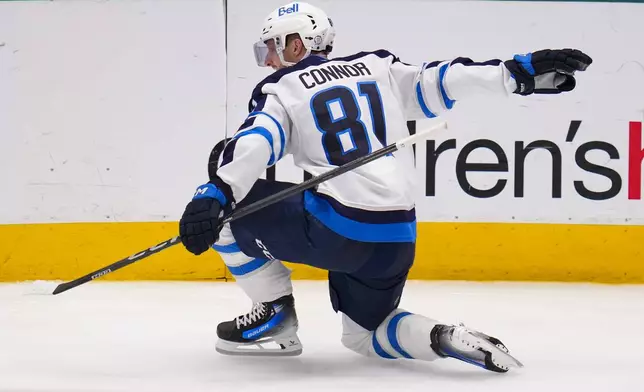 Winnipeg Jets left wing Kyle Connor reacts after scoring a goal against the Dallas Stars during the third period of an NHL hockey game Thursday, April 10, 2025, in Dallas. (AP Photo/Julio Cortez)
