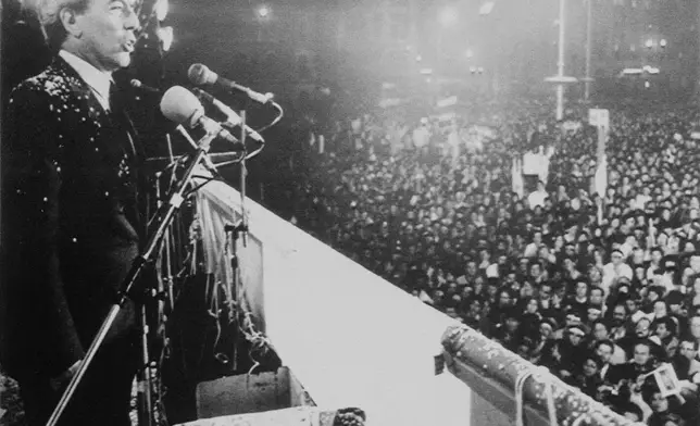 FILE - Writer Mario Vargas Llosa speaks at a rally in Lima, Peru, Aug. 21, 1987, to a crowd of more than 50,000 people. (AP Photo/A. Balaguer, File)