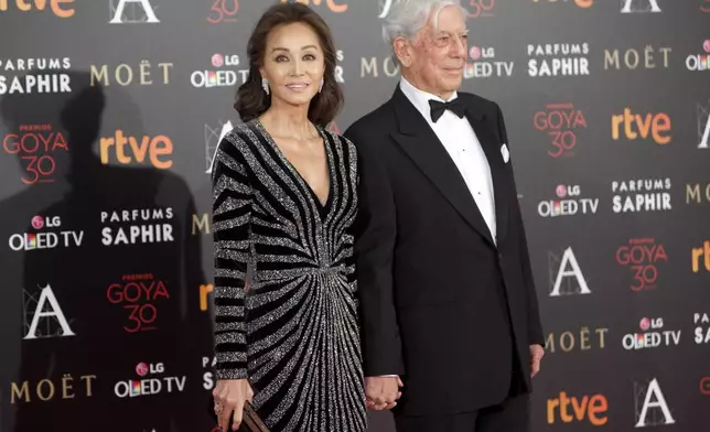 FILE - Isabel Preysler, left, and writer Mario Vargas Llosa arrive at the red carpet of the Goya Film Awards Ceremony in Madrid, Spain, Feb. 6, 2016. (AP Photo/Abraham Caro Marin, File)