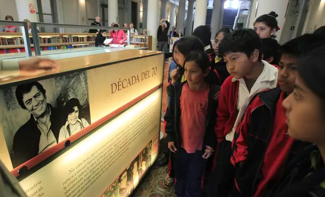 FILE - Students learn about Peruvian writer Mario Vargas Llosa at a public library in Lima, Peru, Oct. 7, 2010. (AP Photo/Martin Mejia, File)