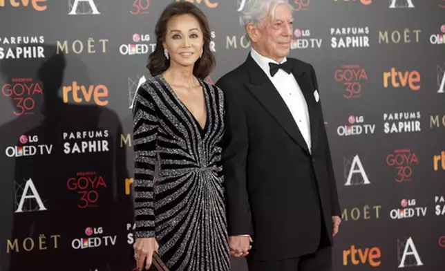 FILE - Isabel Preysler, left, and writer Mario Vargas Llosa arrive at the red carpet of the Goya Film Awards Ceremony in Madrid, Spain, Feb. 6, 2016. (AP Photo/Abraham Caro Marin, File)