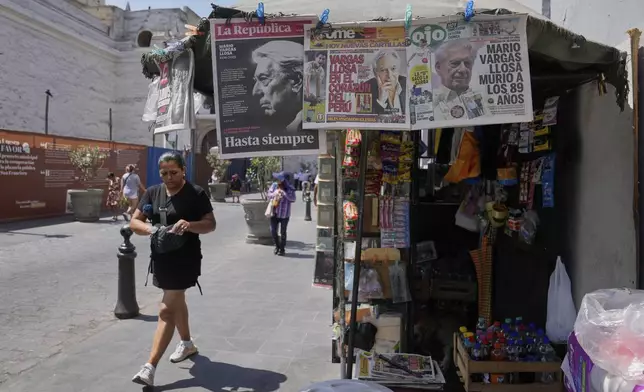 Newspapers for sale carry the news of the death of Peruvian author and Nobel literature laureate Mario Vargas Llosa at a kiosk in Lima, Peru, Monday, April 14, 2025. (AP Photo/Martin Mejia)