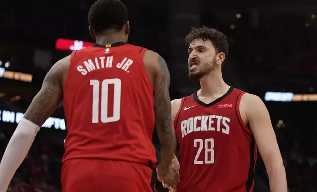 Houston Rockets forward Jabari Smith Jr. (10) celebrates with center Alperen Sengun (28) after making a shot during the second half of Game 1 of an NBA basketball first-round playoff series against the Golden State Warriors in Houston, Sunday, April 20, 2025. (AP Photo/Ashley Landis)