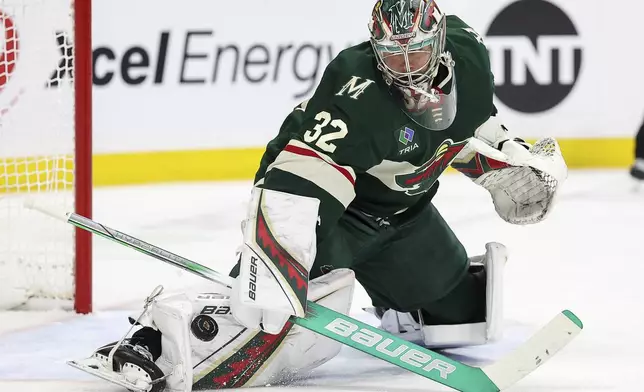 Minnesota Wild goaltender Filip Gustavsson (32) makes a save against the Dallas Stars during the second period of an NHL hockey game Sunday, April 6, 2025, in St. Paul, Minn. (AP Photo/Matt Krohn)