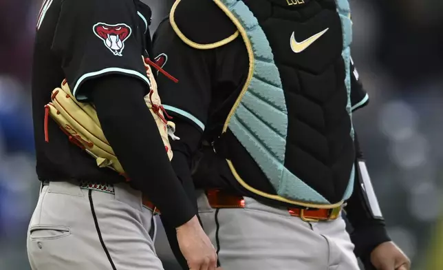 Arizona Diamondbacks closing pitcher Drey Jameson left, celebrates with catcher Jose Herrera right, after defeating the Chicago Cubs in a baseball game Sunday, April 20, 2025, in Chicago. (AP Photo/Paul Beaty)