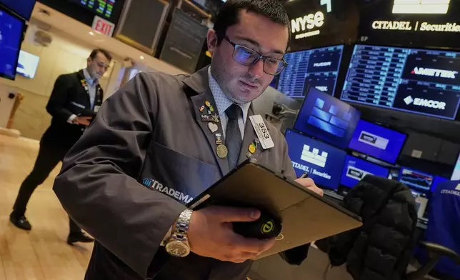 Trader Drew Cohen works on the floor of the New York Stock Exchange, Monday, April 14, 2025. (AP Photo/Richard Drew)