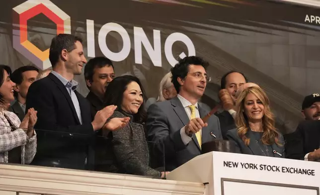IonQ, Inc. CEO &amp; President Niccolo de Masi, second from right, gavels trading closed at the New York Stock Exchange, Monday, April 14, 2025. (AP Photo/Richard Drew)