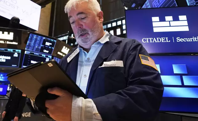 Trader Edward McCarthy works on the floor of the New York Stock Exchange, Monday, April 14, 2025. (AP Photo/Richard Drew)